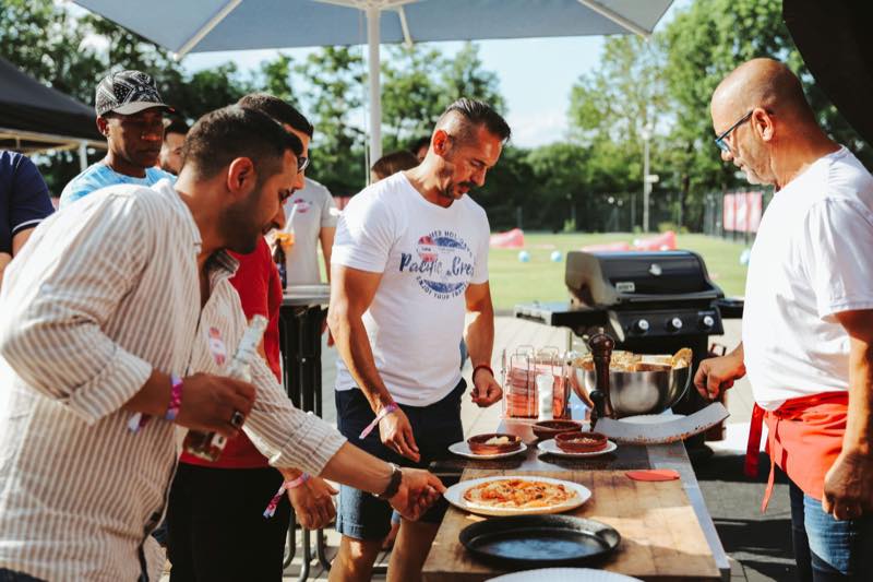 Frisch gebackene Pizza wird an die Gäste gereicht
